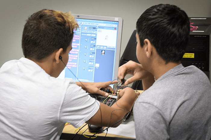 Two sudents doing hands-on Raspberry Pi projects with Scratch coding