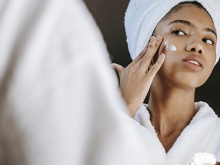 girl putting on product