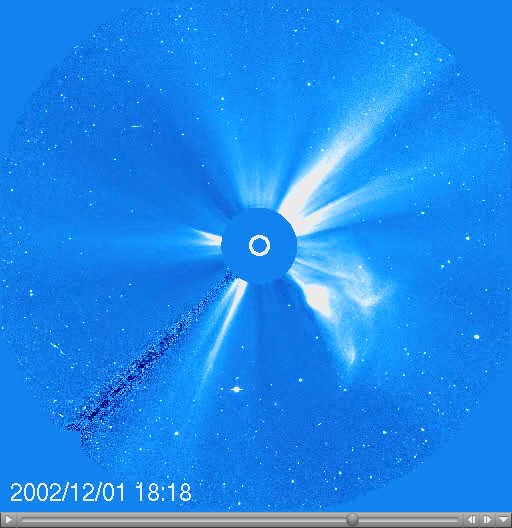 A coronagraph shows a large white flare emerging from the surface of the Sun with a timestamp of 2002/12/01 18:18