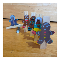 Gingerbread-themed Rube Goldberg Machine with gingerbread people set up like dominoes - Educator's Corner Gingerbread STEM Experiments