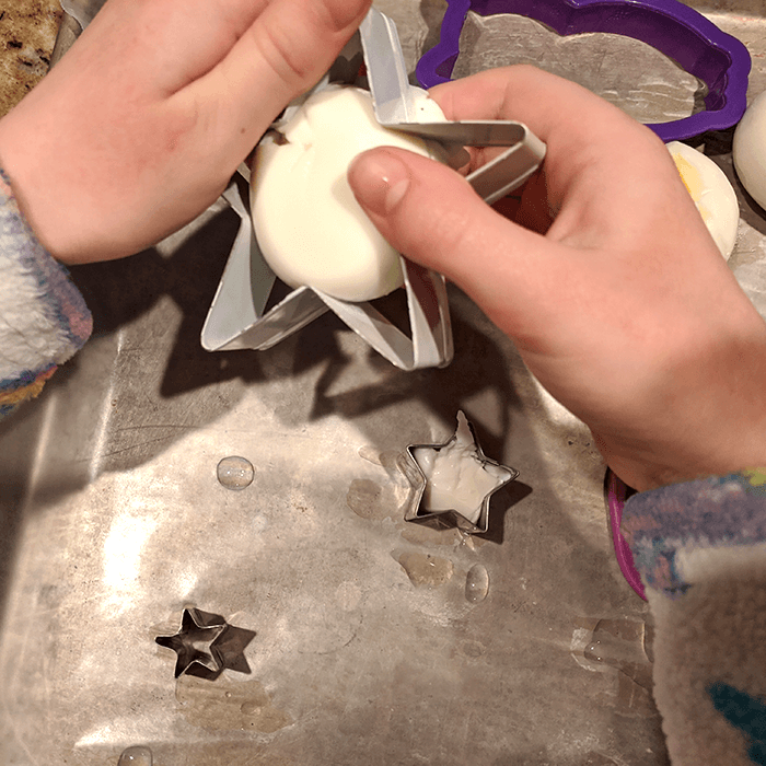 Hard-boiled egg being pressed into a star-shaped mold