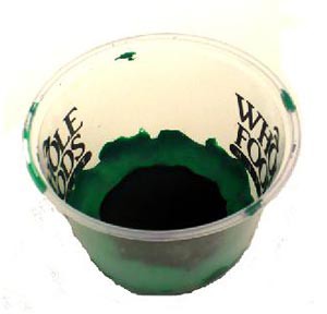 Felt lines the inside bottom of a plastic cup and is held in place with clay pressed along the edge of the felt
