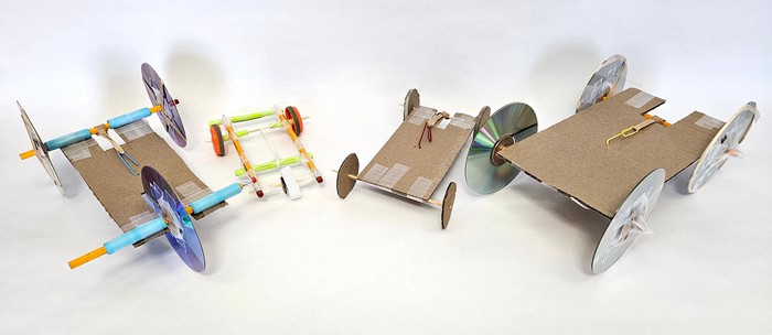Examples of rubber band cars made from different craft and office supplies