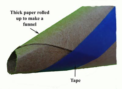 Thick paper is rolled at an angle to create a funnel and taped to hold its shape