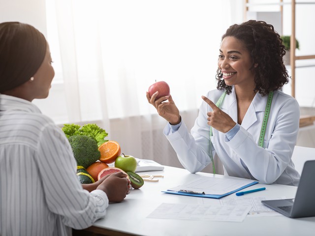 nutritionist pointing to apple