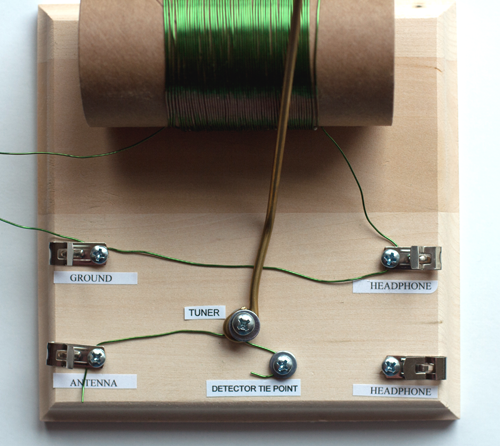 Metal wire connects the tuning rod screw to the antenna and detector tie point in a homemade crystal radio