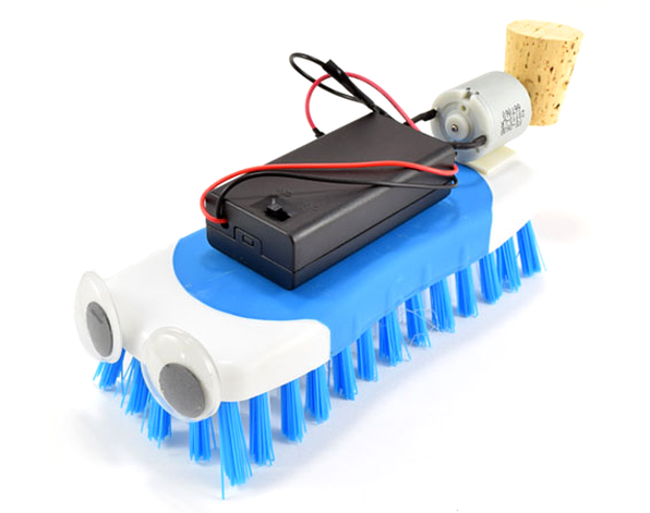 Brushbot robot made from scrub brush, battery pack, motor, and cork