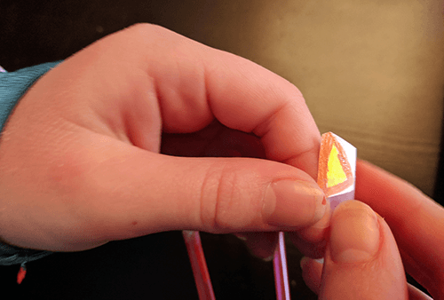 Student attaching paper fingernails to straws of a robot hand