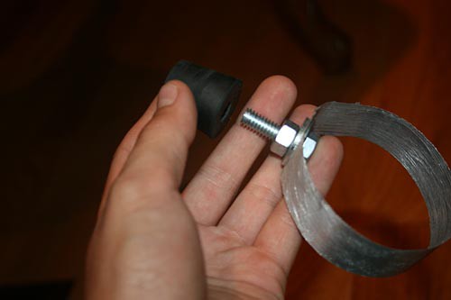 A nut, bolt and two washers are secured through a notch in an aluminum ring and a rubber stopper is put on the bolts end