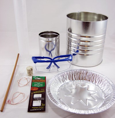 A large tin can, a small tin can, a wooden dowel, an aluminum pie pan, rubber bands, a cork and safety glasses