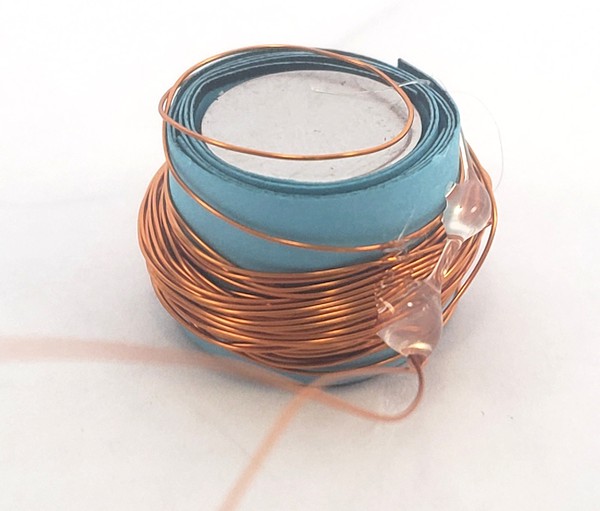 coil of wire secured by drops of glue 