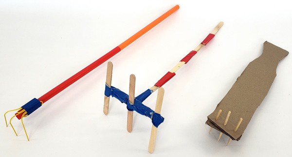 A back scratcher made from straws and paper clips, one made from popsicle sticks and duct tape, and one made from cardboard and wooden skewers.