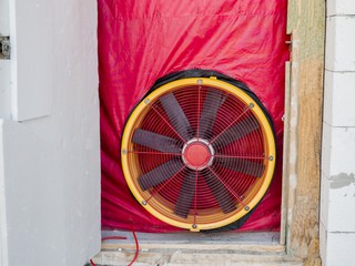 large fan inserted in doorway for blower door test