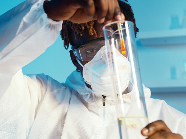 man testing yellow liquid