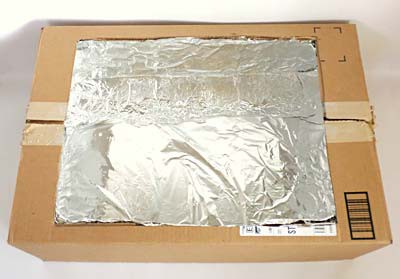 The inside of a cardboard box is lined with aluminum foil