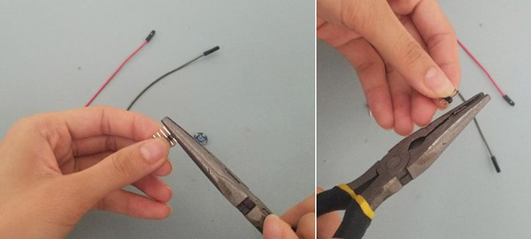 Needle nose pliers pinching breakaway male header pins. One male header pin snapped off of breakaway male header pin rail. 