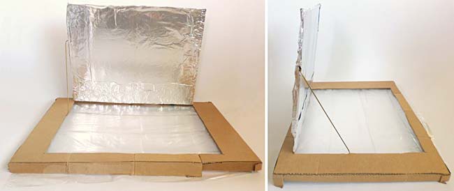 A coat hanger wire is used to hold open a flap in the lid of a cardboard box