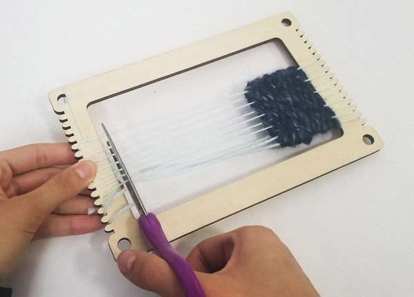 Cutting patch off of loom. 
