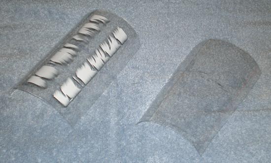 The straight walls of a plastic bottle are removed and cut in half to form two concave sheets