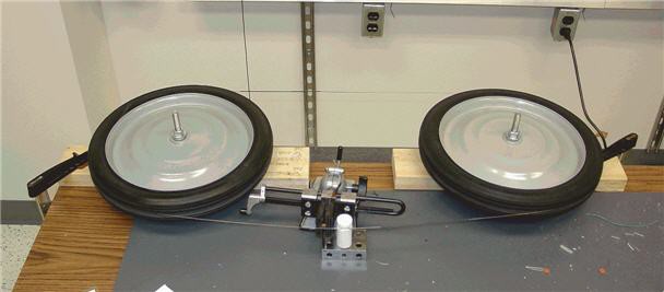 Two rubber wheels are used as spools to move the wire across the read and write head