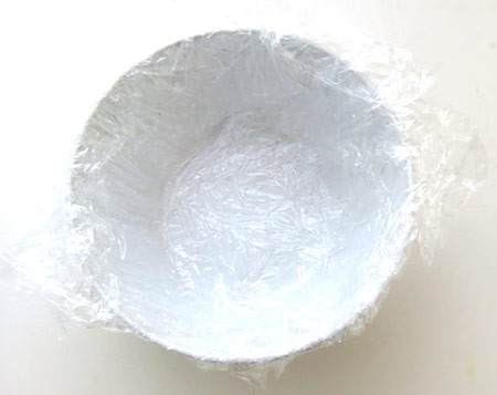 A bowl lined with two layers of plastic wrap