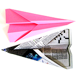 Two paper airplanes with different design elements
