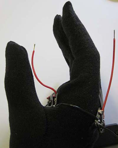 Positive wires protruding from the front and back side of an LED glove