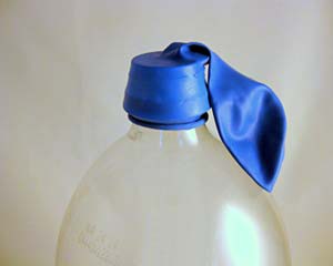 A balloon tightly fit over a bottle's opening