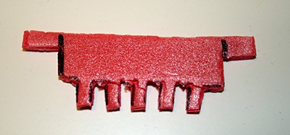 Styrofoam is cut to form a comb with five evenly spaced teeth