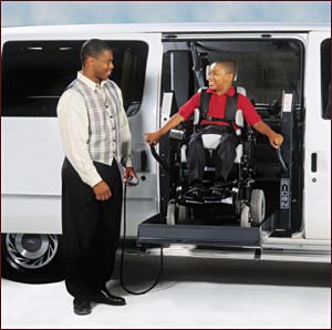 Child in a wheelchair uses a hydraulic lift to easily enter a vehicle