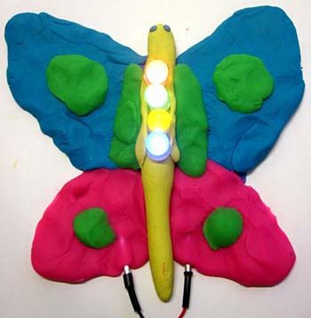 A butterfly made out of Play Doh and LEDs