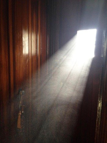 Dust being shined on by sunlight through a window.
