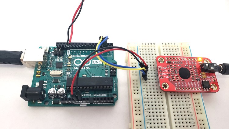 Elechouse Voice Recognition V3 module inserted into a breadboard and connected to an Arduino UNO with jumper wires 