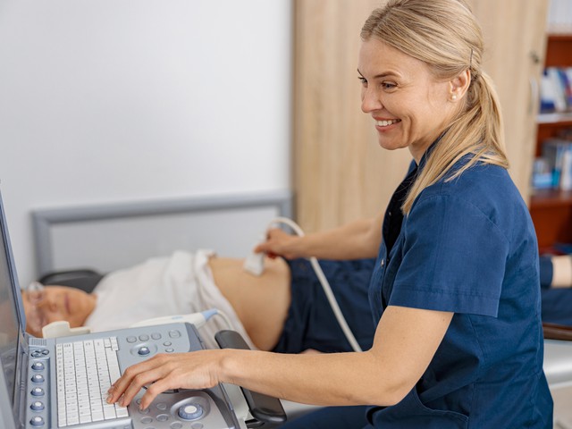 smiling doctor performing ultrasound