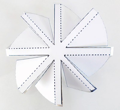 Angled fan blades are made by folding sections of cut aluminum along the lines of a template