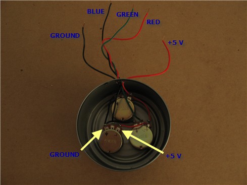 Five wires are connected to three potentiometers inside an aluminum can