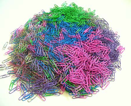 A large pile of multi-colored paperclips