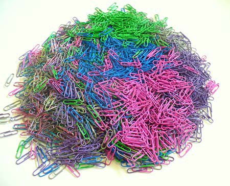 A large pile of multi-colored paperclips