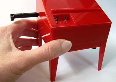 A hand holds the left side of a theremin