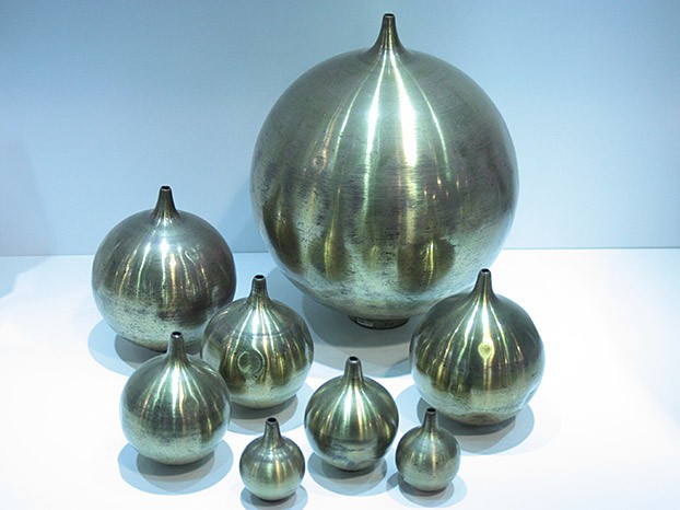 An assortment of Helmholtz resonators, nearly spherical metal containers with small openings at one end 