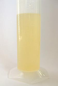 A solution of vitamin C and water in a graduated cylinder