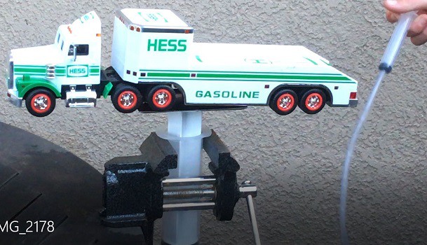 Toy truck being lifted by a hydraulic system