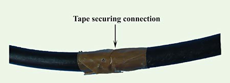 Tape is wrapped around a tube to secure where two pieces of tubing meet