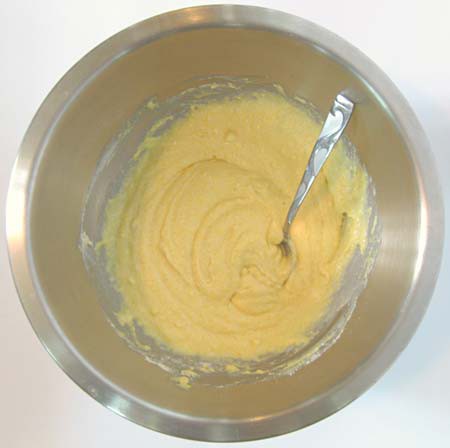 Yellow batter is mixed in a metal bowl