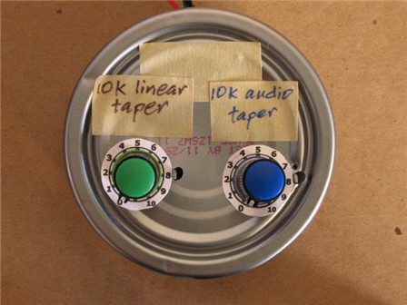 Two potentiometer dials mounted to the bottom of an aluminum can