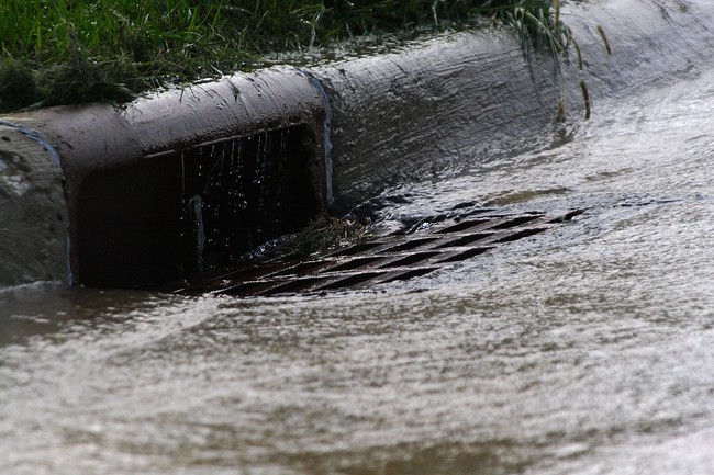 A storm drain collecting water from the street.  