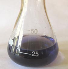 An erlenmeyer flask contains a dark blue solution