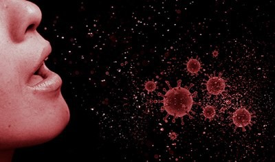 a person coughing with droplets in the air showing virus particles.