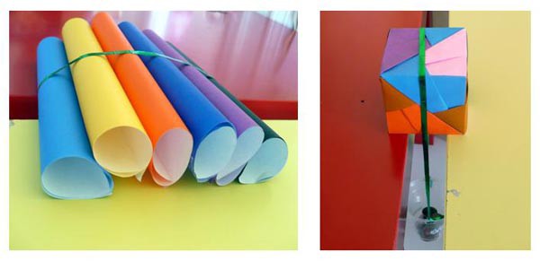 Two photos of a bundle of rolls of paper and a cube made of paper attached to a table