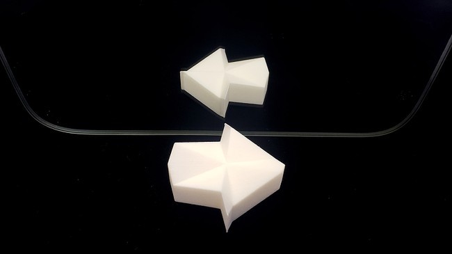 A 3D printed object in front of a mirror.